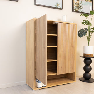 Renne shoe cabinet in oak finish with one door open, displaying multiple adjustable shelves and extra bottom storage space for sneakers. The cabinet features vertical fluted door panels, modern minimalist style, and 15mm MDF construction, making it a practical storage solution for entryways and living rooms.