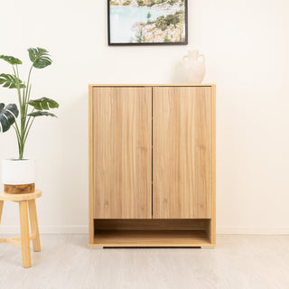 Renne shoe cabinet in oak wood finish with closed double doors, minimalist vertical fluted design, and a bottom open shelf for quick shoe storage. A modern storage solution that blends with New Zealand home interiors.