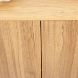Close-up of the Renne shoe cabinet front doors in oak finish, showing the vertical fluted design and smooth wood grain detail for a modern cabinet style.