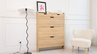 Risa Slim Shoe Cabinet in a modern living space, tall oak finish design with slim profile and multiple compartments, styled beside a cosy armchair and floor lamp.