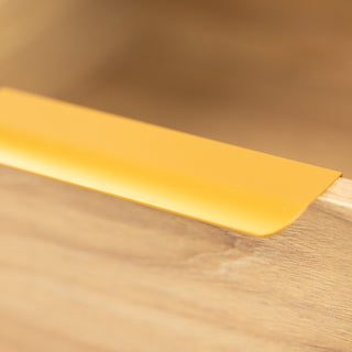 Close-up of the Ruelle 6 Drawer dresser showing the brass gold handle fixed on the oak finish drawer front, highlighting the elegant contrast and smooth detail.