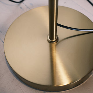 Close up of the Solara Fluted Lantern Floor Lamp base, showing the brushed brass finish and sturdy circular design for stability.