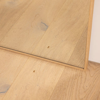 Close-up of the Solene X full-length mirror showing the bottom wooden PS frame resting neatly on a light oak timber floor. The 45 mm deep frame highlights its fine craftsmanship and clean joinery, while the 4 mm double silver glass reflects with clear precision, blending naturally with warm home interiors.