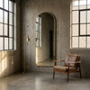 C&F Creation Svelte Aurelia Arched Full Length Mirror 160x60cm gold frame against industrial wall