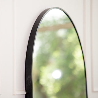 Close-up of the Titan X arched full-length mirror showing its smooth black aluminium frame and elegant curve. The premium 4mm glass reflects soft natural light, showcasing the mirror’s refined craftsmanship and modern minimalist design ideal for contemporary New Zealand interiors.