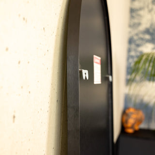 Close-up of the Titan X arched full-length mirror showing its upgraded rear hook system and 5 mm MDF backing. The improved mounting structure provides strong wall support, ensuring both safety and stability for wall-mounted or floor-standing use.