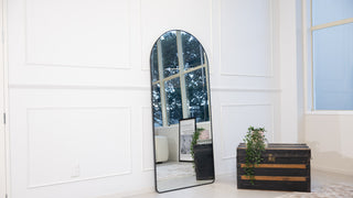 Titan X 180×80cm arched full-length mirror with black aluminium frame, featured as a freestanding mirror in a bright interior setting, part of C&F Creation’s best seller collection.