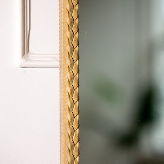 Detailed close-up of the Tresson gold full-length mirror’s braided PS frame, showcasing its refined woven texture and metallic sheen. This 180x80cm mirror with 4mm clear glass blends luxury with simplicity, perfect for bright modern interiors across New Zealand homes.