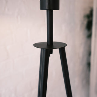 Close up of the Vanta floor lamp’s upper frame, showing the matte black metal structure and tripod connection point against a soft neutral background.