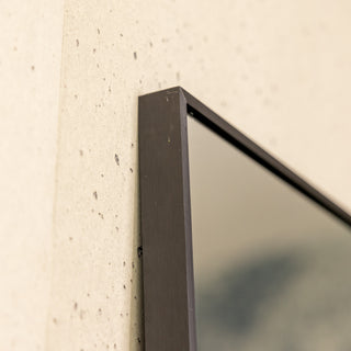 Close-up view of the Zenith X full-length mirror’s 30 mm black aluminium alloy frame, highlighting its sleek straight-edged profile and premium brushed finish. The ultra-clear 3 mm glass sits perfectly flush within the frame, showcasing precision craftsmanship and minimalist elegance.
