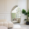 Cascade X irregular frameless full-length mirror leaning beside a cream tufted couch with palm plant in an NZ living room, C&F Creation