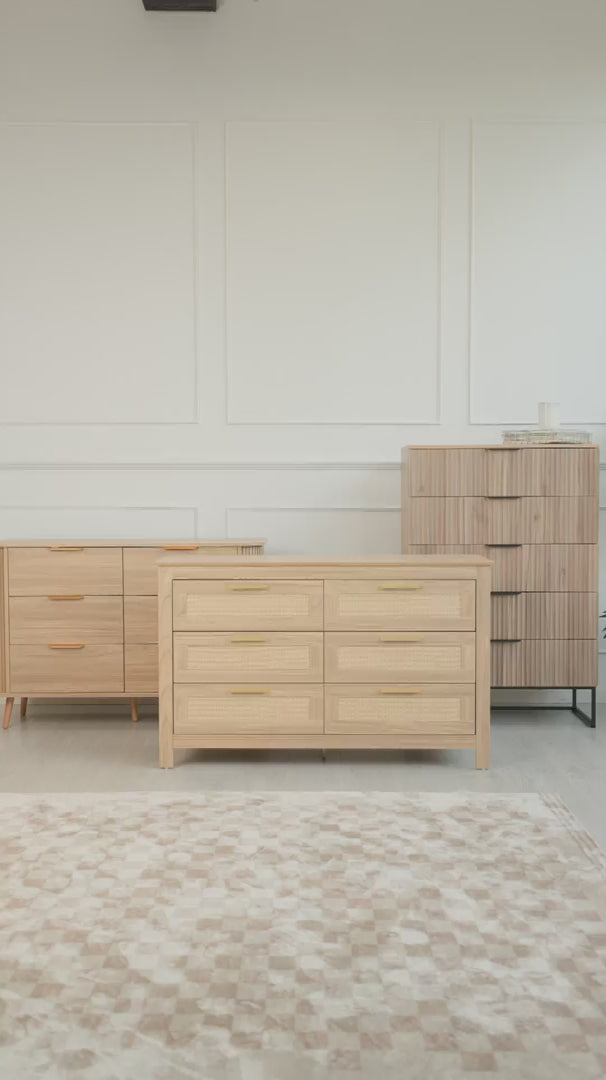 Lifestyle video showcasing the oak-finish six-drawer dresser from C&F Creation’s new furniture collection. The dresser is styled in a modern living room with a beige armchair, decorative artwork, and natural light from large windows. Part of our special new launch promotion featuring five new oak furniture designs.